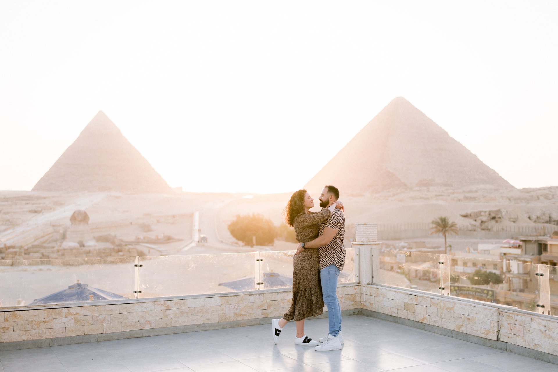 Honeymoon couple sharing sunset beside the Giza Pyramids