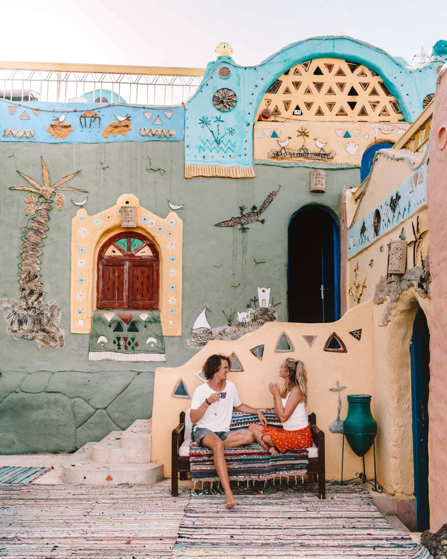 Couple enjoying a colourful Nubian guesthouse in Aswan