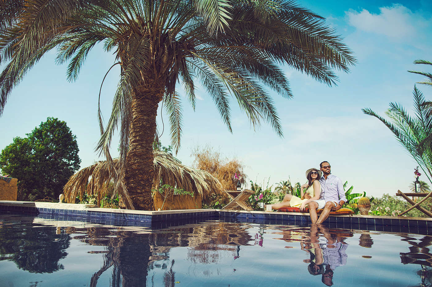 Couple relaxing beside a peaceful Fayoum pool