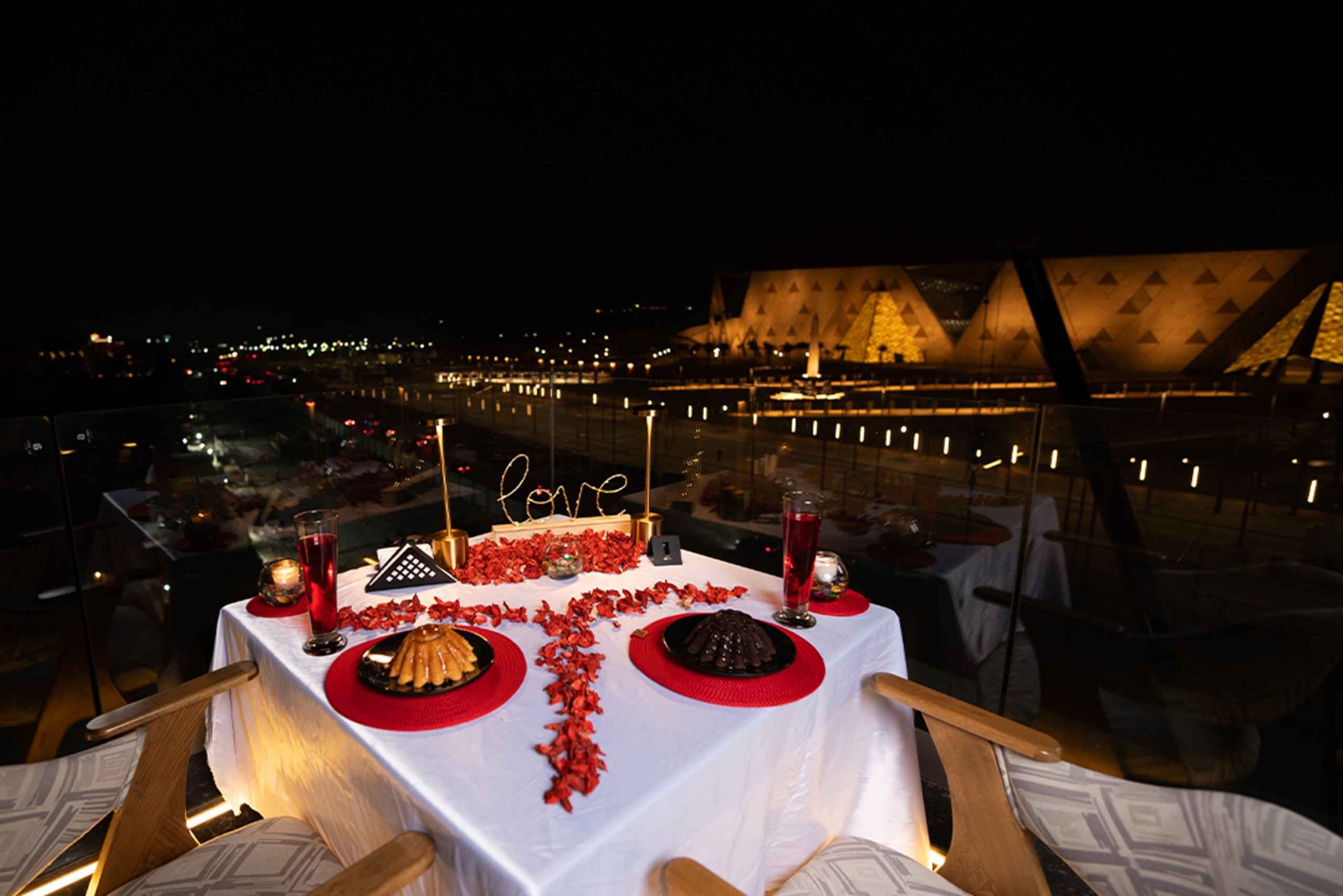 Romantic table overlooking the Grand Egyptian Museum and Pyramids