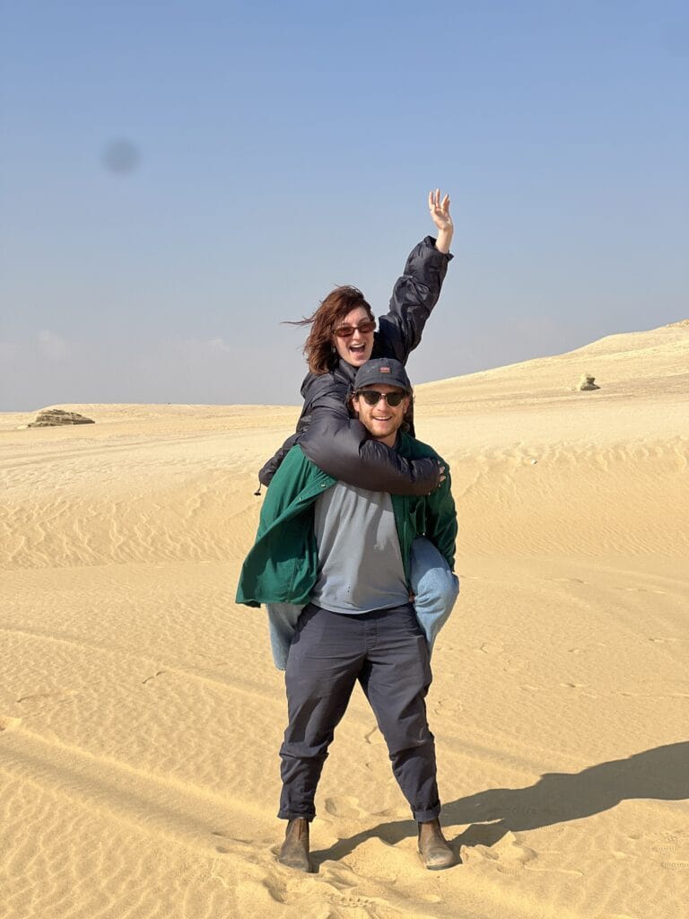 Couple enjoying a playful Fayoum desert adventure