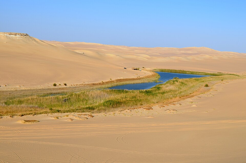 Blue salt lake surrounded by the Siwa Oasis landscape