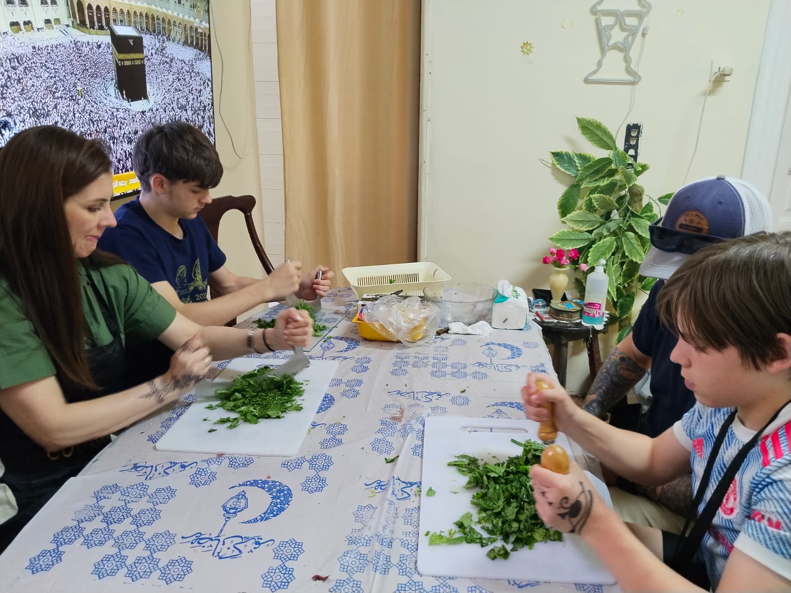 A family of travelers preparing Egyptian food together during an authentic Live Like a Local experience